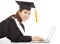 Smiling female graduation lying on floor with laptop