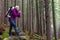 Smiling Female Hiker Staying in Deep Old Forest