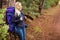 Smiling female hiker waiting by the side of the road