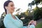 Smiling female jogger checking her fitness band