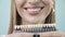 Smiling female mouth with natural white teeth, selective focus. Close up smiling woman face with perfect smile laughing to camera