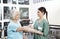 Smiling Female Nurse Putting Crepe Bandage On Senior Woman\'s Han