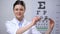 Smiling female ophthalmologist recommending eyeglasses, eyesight correction