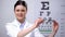 Smiling female ophthalmologist recommending eyeglasses, eyesight correction