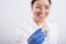 Smiling female orthodontist holds two transparent aligners. The dentist demonstrates the bite correction device