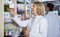 Smiling female pharmacist posing in drugstore