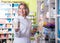Smiling female pharmacist posing in drugstore