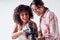 Smiling Female Photographer Holding Camera With Model In Studio Portrait Session