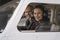 Smiling Female Pilot and Flight Instructor Looking Through The Cockpit Window