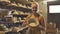 Smiling Female pottery artist showing brown clay bowl to the camera