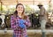 Smiling female proffesional farmer standing near cows