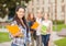 Smiling female student with folders