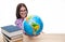 Smiling female student sitting with globe