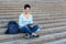 Smiling female student working with tablet outdoors