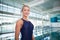 Smiling female swimmer by pool at leisure center