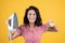 smiling female with trendy clothes ironing with steaming iron, modern life