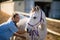 Smiling female vet checking horse