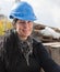 Smiling female worker in blue hard hat