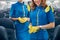 Smiling females stewardesses posing at the photo camera in the salon of commercial aircraft