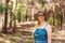 Smiling fifty-year-old woman in mirrored glasses and hat in the summer forest