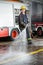 Smiling Fireman Spraying Water During Training