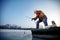 Smiling fisherman catch fish on the frozen river in winter