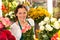 Smiling florist flower shop colorful making bouquet