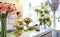 Smiling florist woman making bunch at flower shop