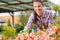 Smiling florist working in garden center