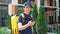 Smiling food delivery man courier walks street watching navigation in smartphone