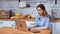 Smiling freelancer young woman working remotely use laptop. Medium shot on RED camera