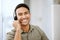 Smiling, friendly call center agent with headset for online consulting in an IT tech agency. Face of male ecommerce