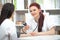 A smiling friendly doctor takes a patient in his office and measures pressure. Woman gives medical advice