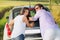 Smiling and funny couple pushing a car