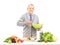 Smiling gentleman prepairing meal with fresh vegetables