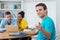 Smiling german male student with group of computer science students