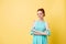 Smiling ginger girl in dress posing with crossed arms