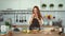 Smiling Ginger Woman Cooking Fresh Meal in Kitchen. Crazy red head girl.