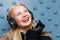 Smiling ginger woman in headphones listening music