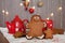 Smiling gingerbread man and a smaller one next to him standing i