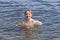 Smiling girl bathes in river