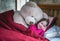 Smiling girl in bed with talking teddy bear
