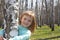 Smiling girl in birch grove