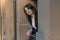 Smiling girl with bob haircut. Portrait of successful business woman on the balcony. Happy woman on break