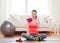 Smiling girl with bottle of water after exercising