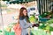 Smiling girl buys cauliflower in greengrocer shop