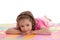 Smiling girl child resting on kids alphabet floor