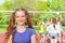 Smiling girl with classmates playing volleyball