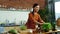 Smiling girl cooking healthy salad at home. Woman tearing lettuce leaves on bowl