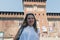 Smiling girl in the courtyard of Sforza Castle in Milan, Italy.